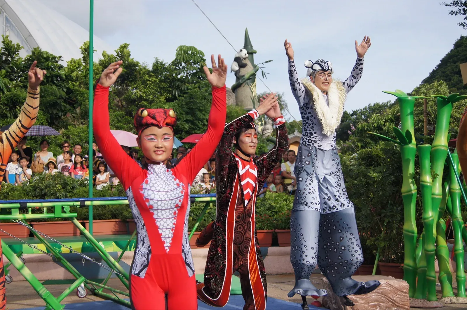 Bamboo Jam acrobats and a silver stilts character posing after the circus show in Hong Kong