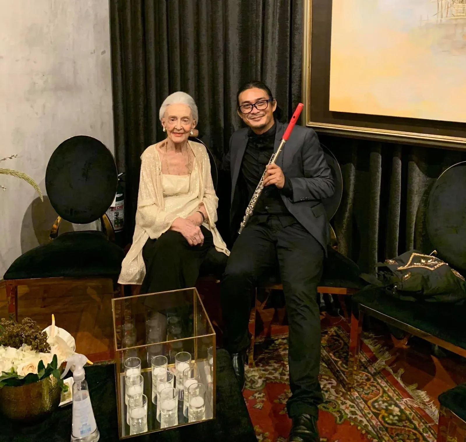 Flute player posing with a guest at a private birthday celebration in Hong Kong