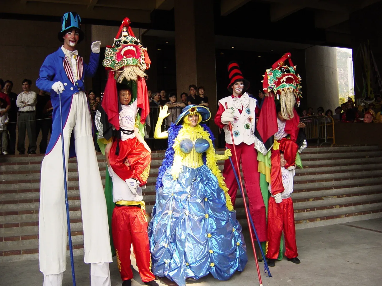 Stilts walkers and dragon-headdress characters at a Chinese New Year parade in Hong Kong