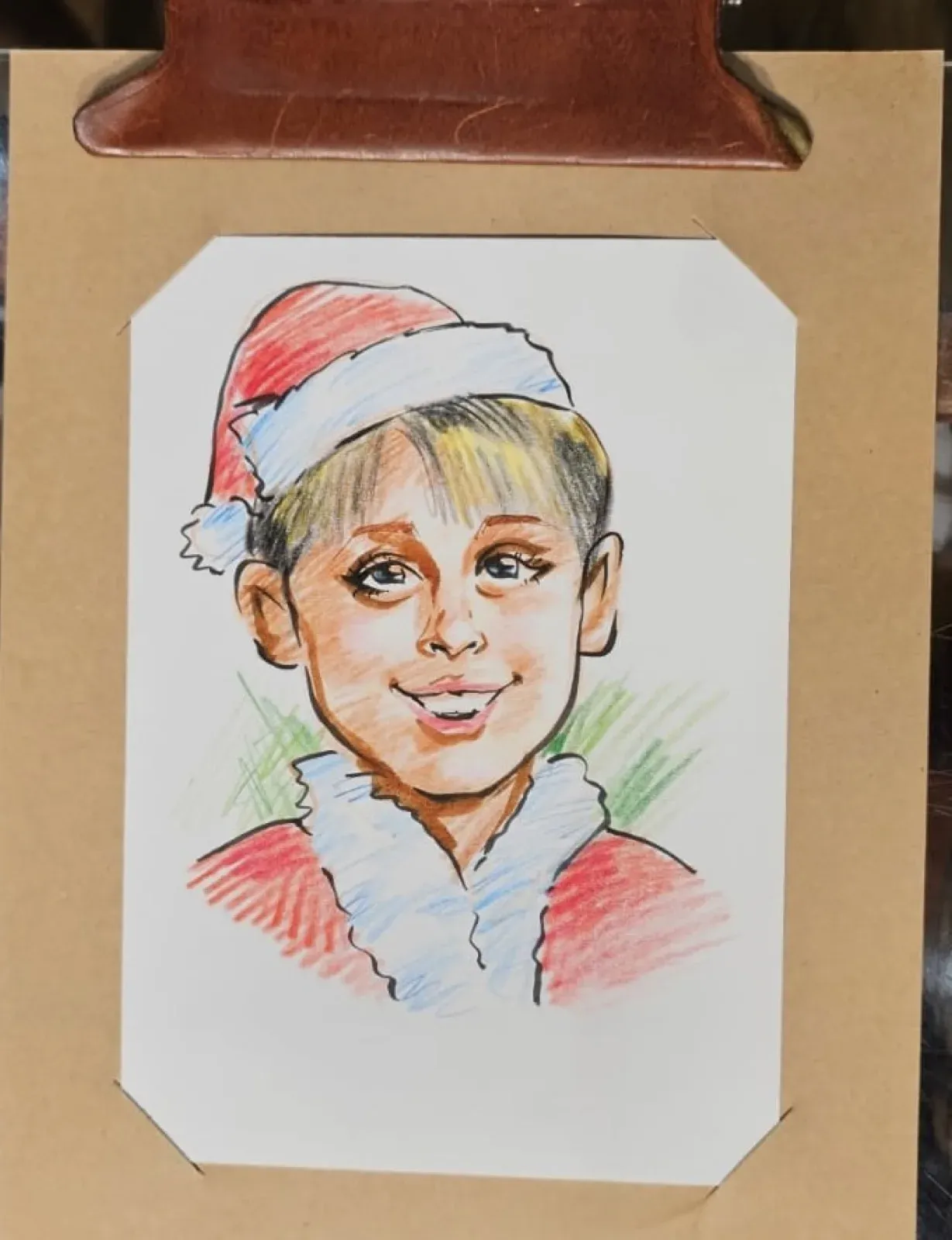 Christmas caricature of a boy in a Santa hat, drawn live at a children's party in Hong Kong