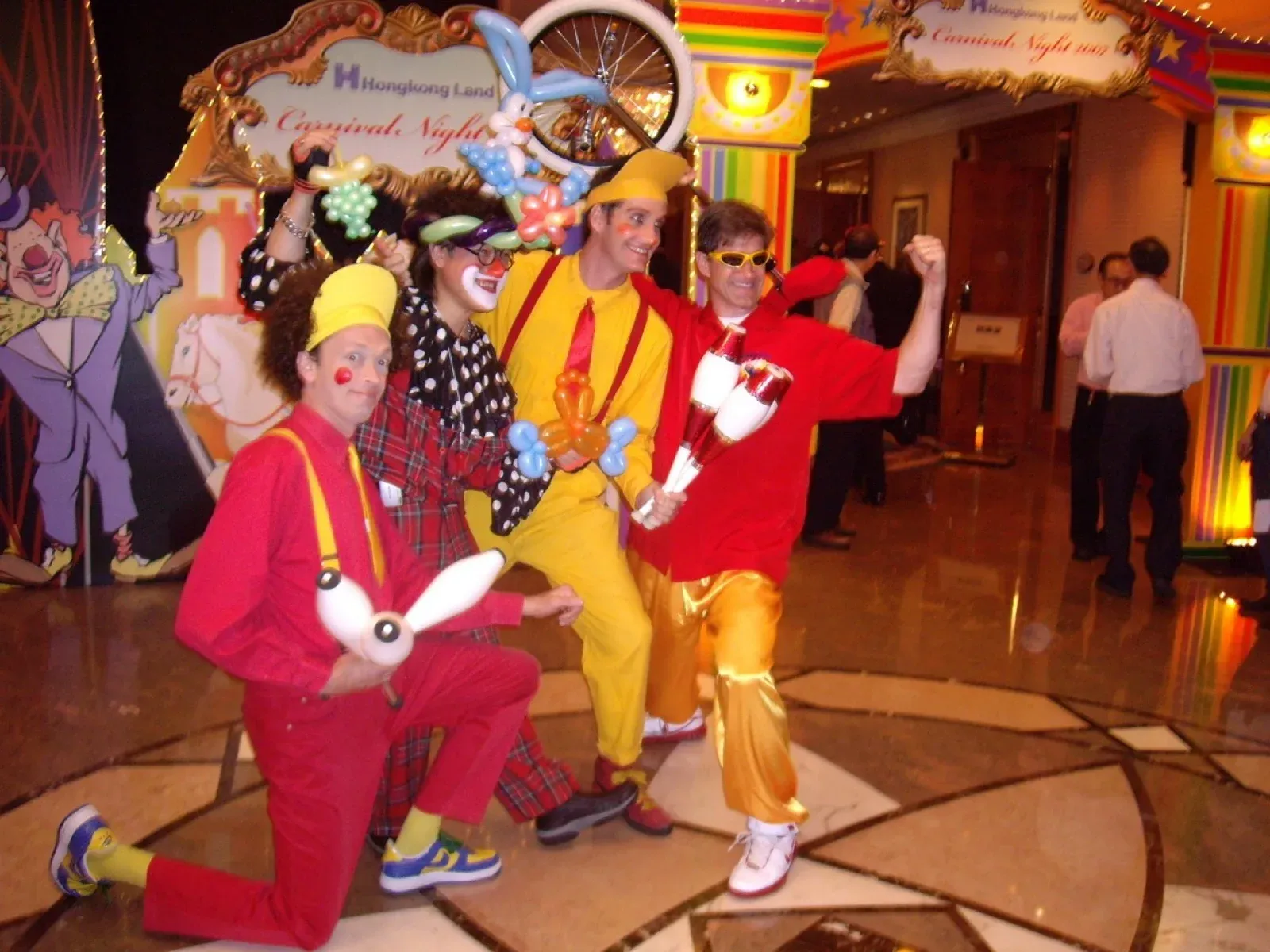 Clowns in bright costumes clowning around at a Christmas corporate party in Hong Kong