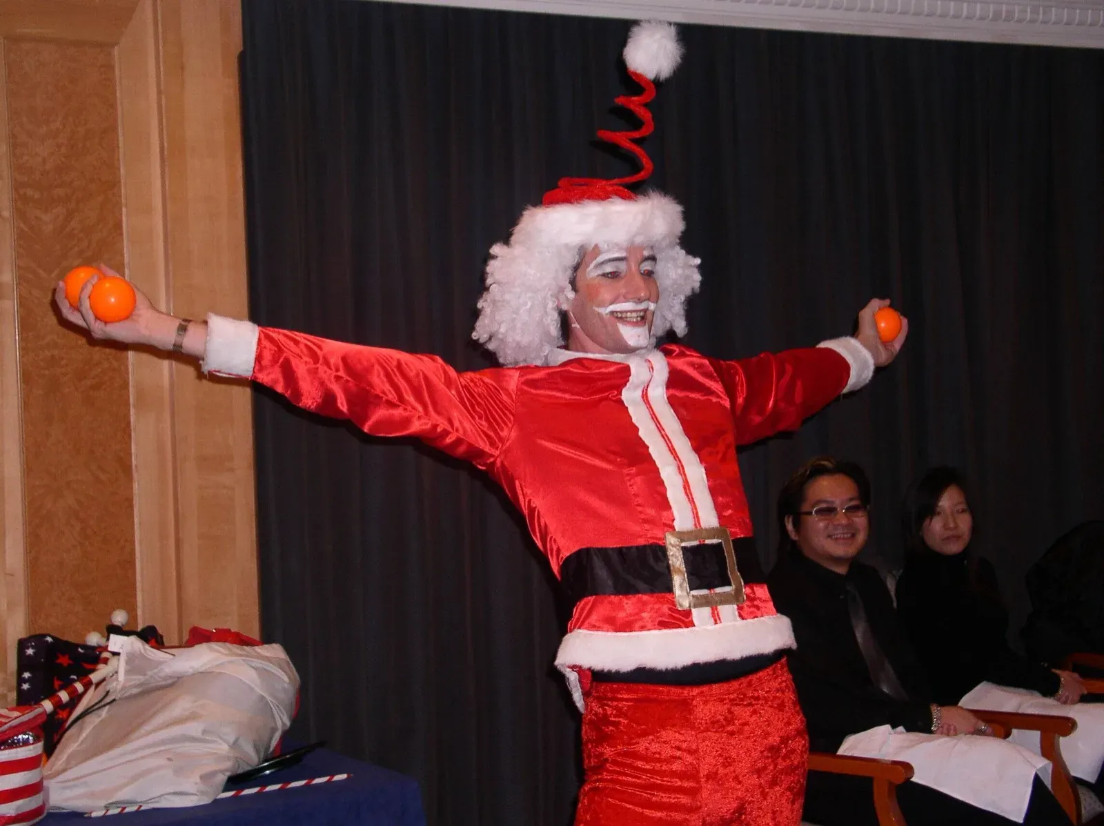 Juggling Santa performing for guests at a Christmas gala dinner in Hong Kong
