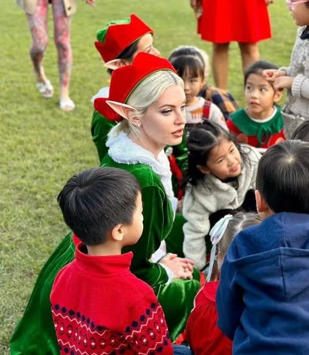 Christmas elf character sitting with children at a Hong Kong event
