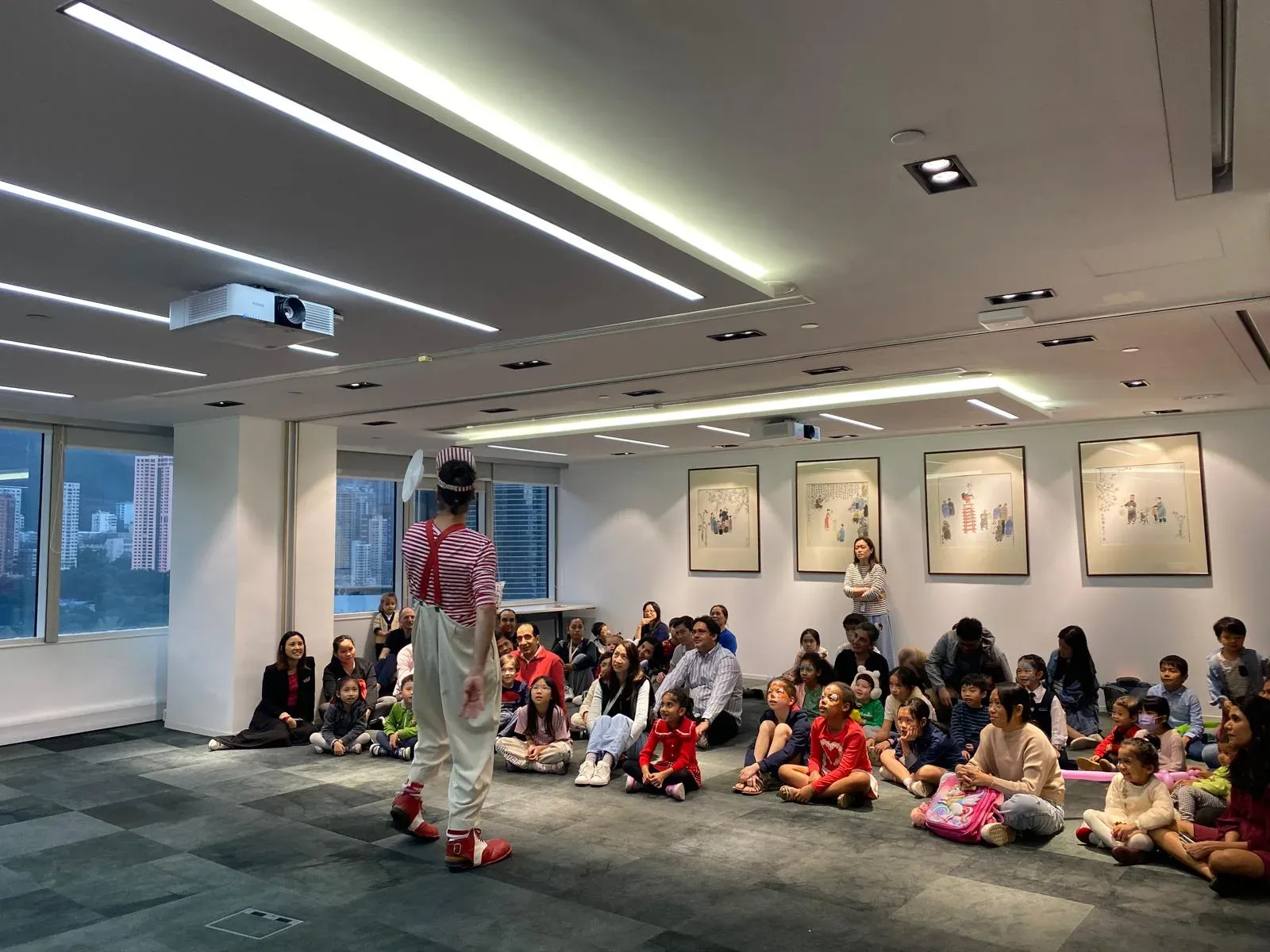 Christmas show for children and families seated on the floor of a Hong Kong office
