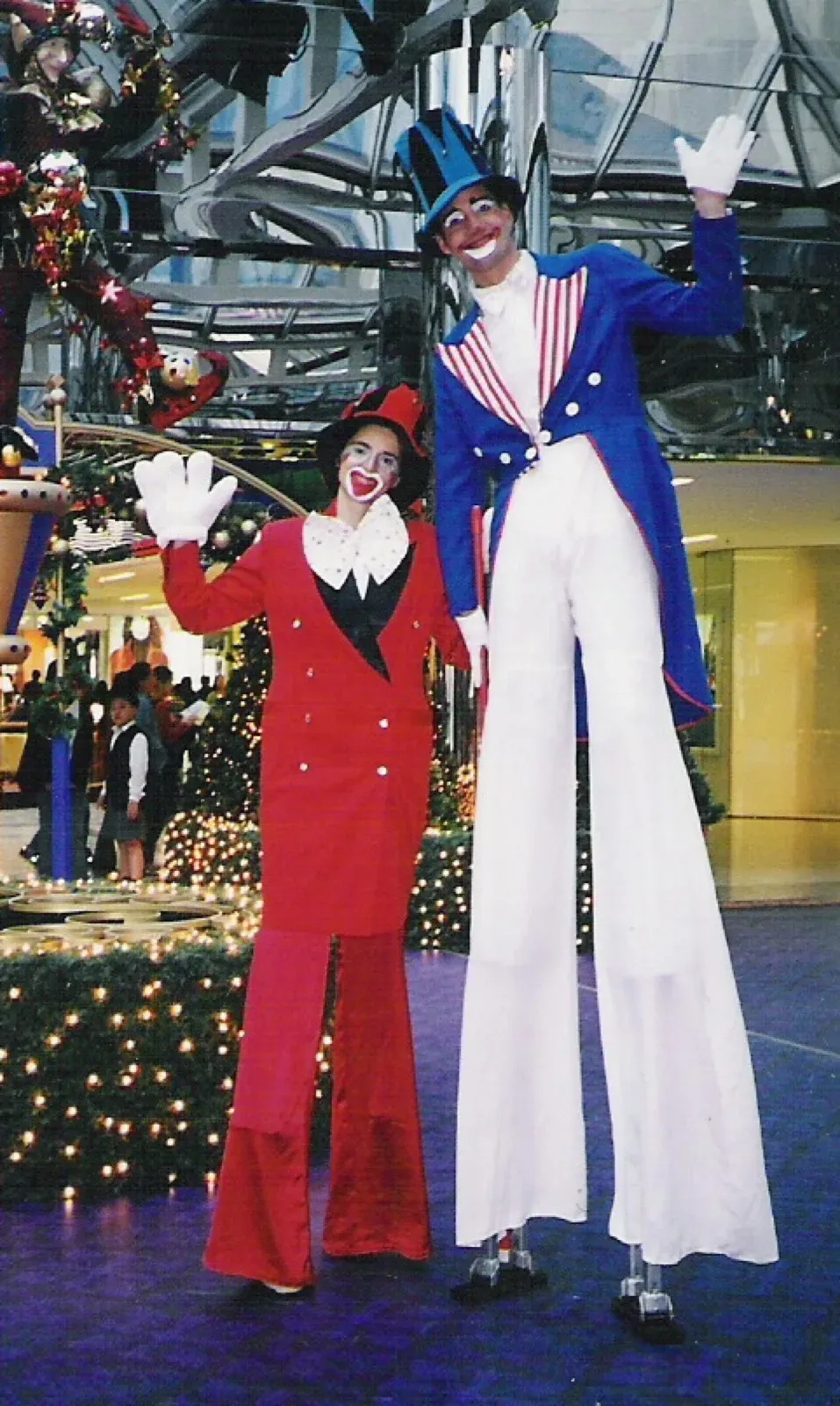 Clown on stilts in hong kong shopping mall with red & blue costume