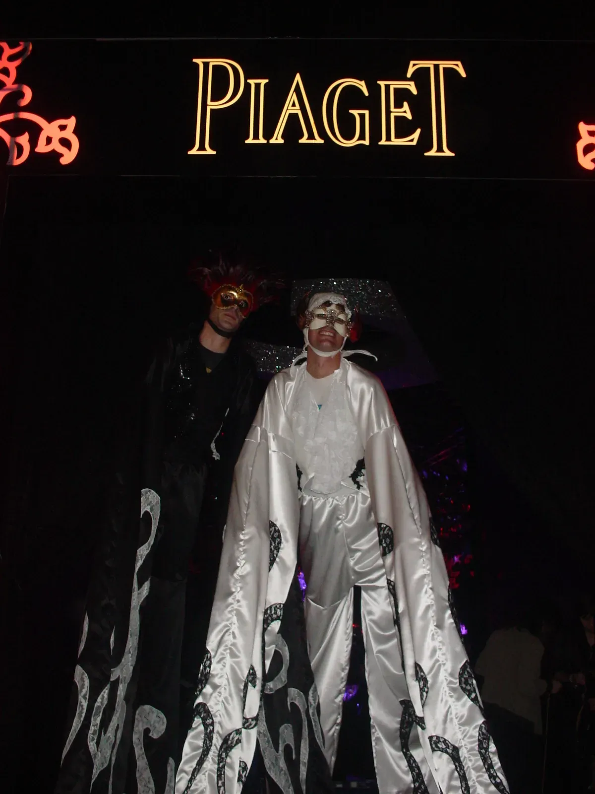Stilts characters in black and white costumes at a Piaget corporate event in Hong Kong