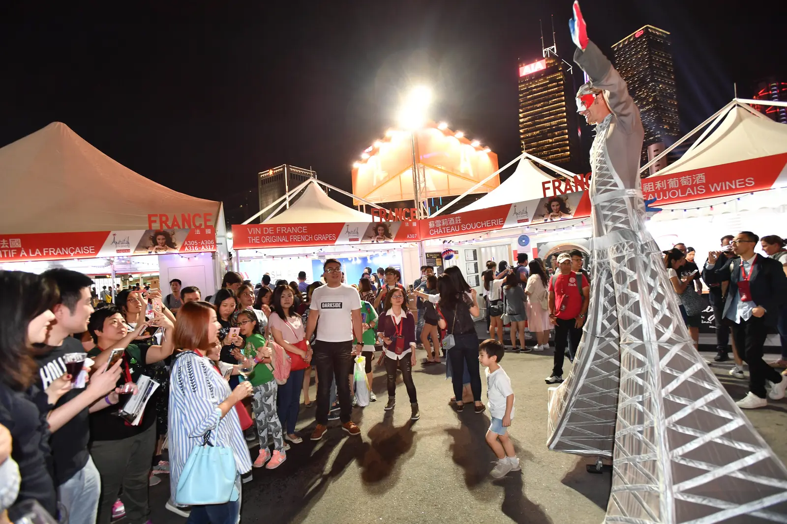 Four costumed mascot characters, including a rabbit and a panda, posing with guests at an event in Hong Kong