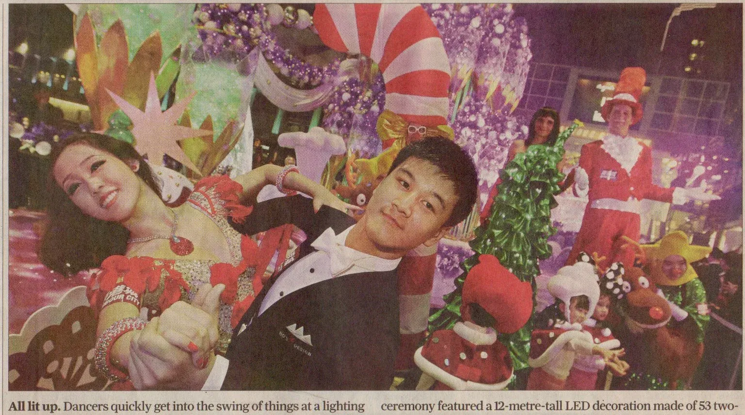 Christmas dancers in Hong Kong shopping mall on newspaper frontpage