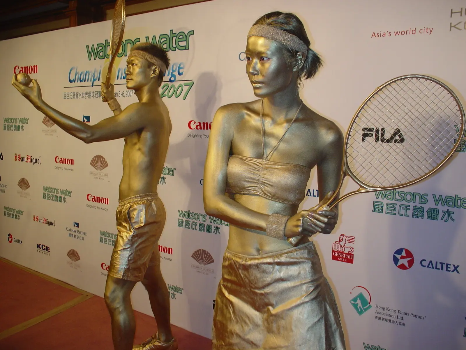 Golden statue mime performers, a boy and a girl