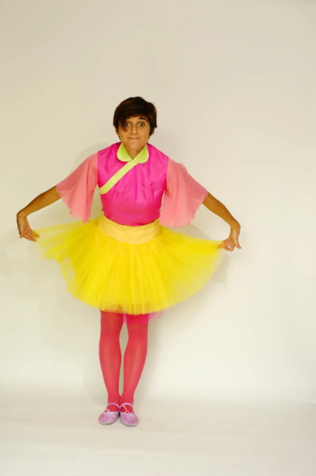 Dancer in a pink top and a yellow tutu skirt