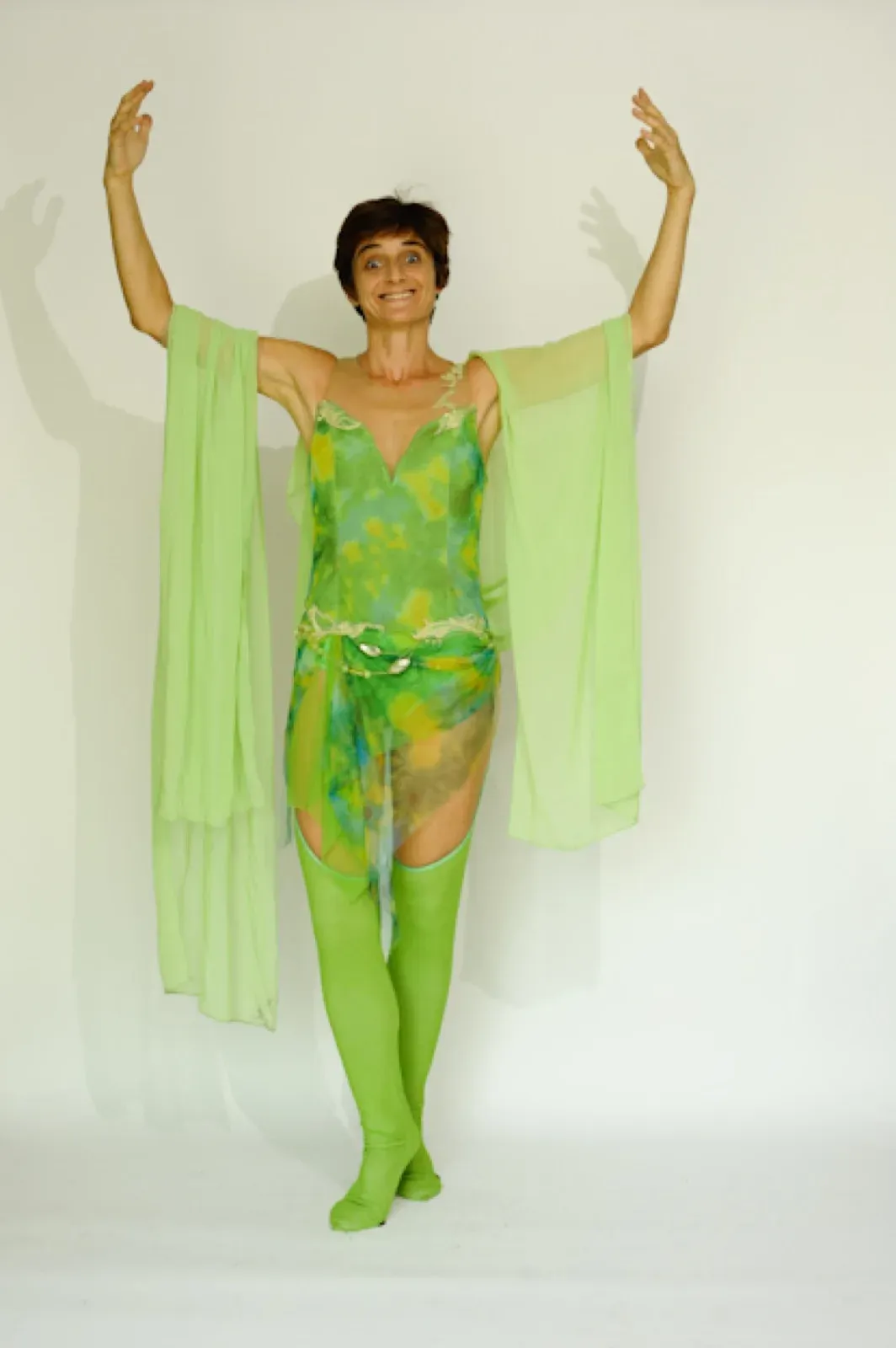 Dancer in a green gauze outfit with long veils
