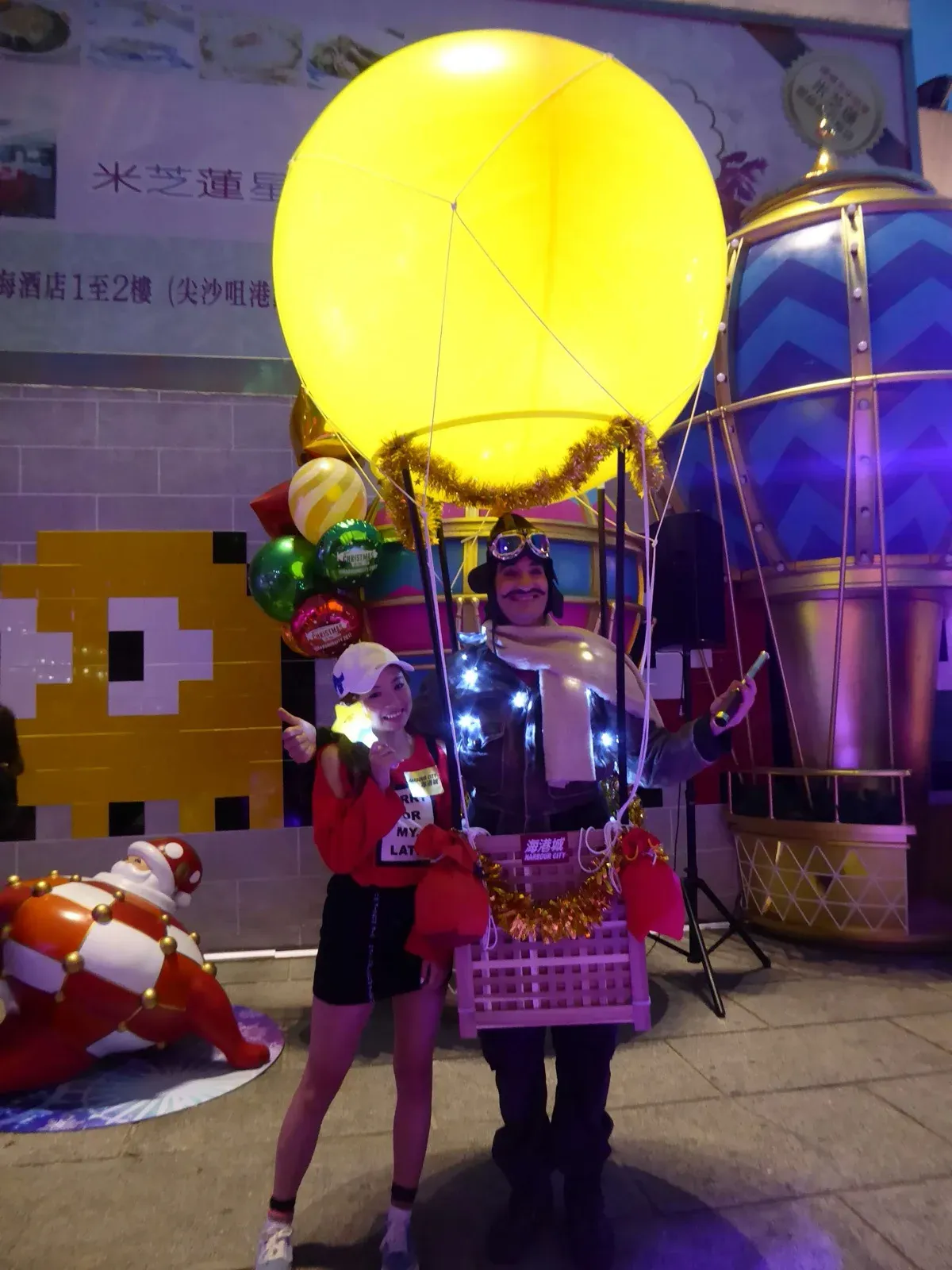 Performer in a glowing LED airship balloon costume at a night event