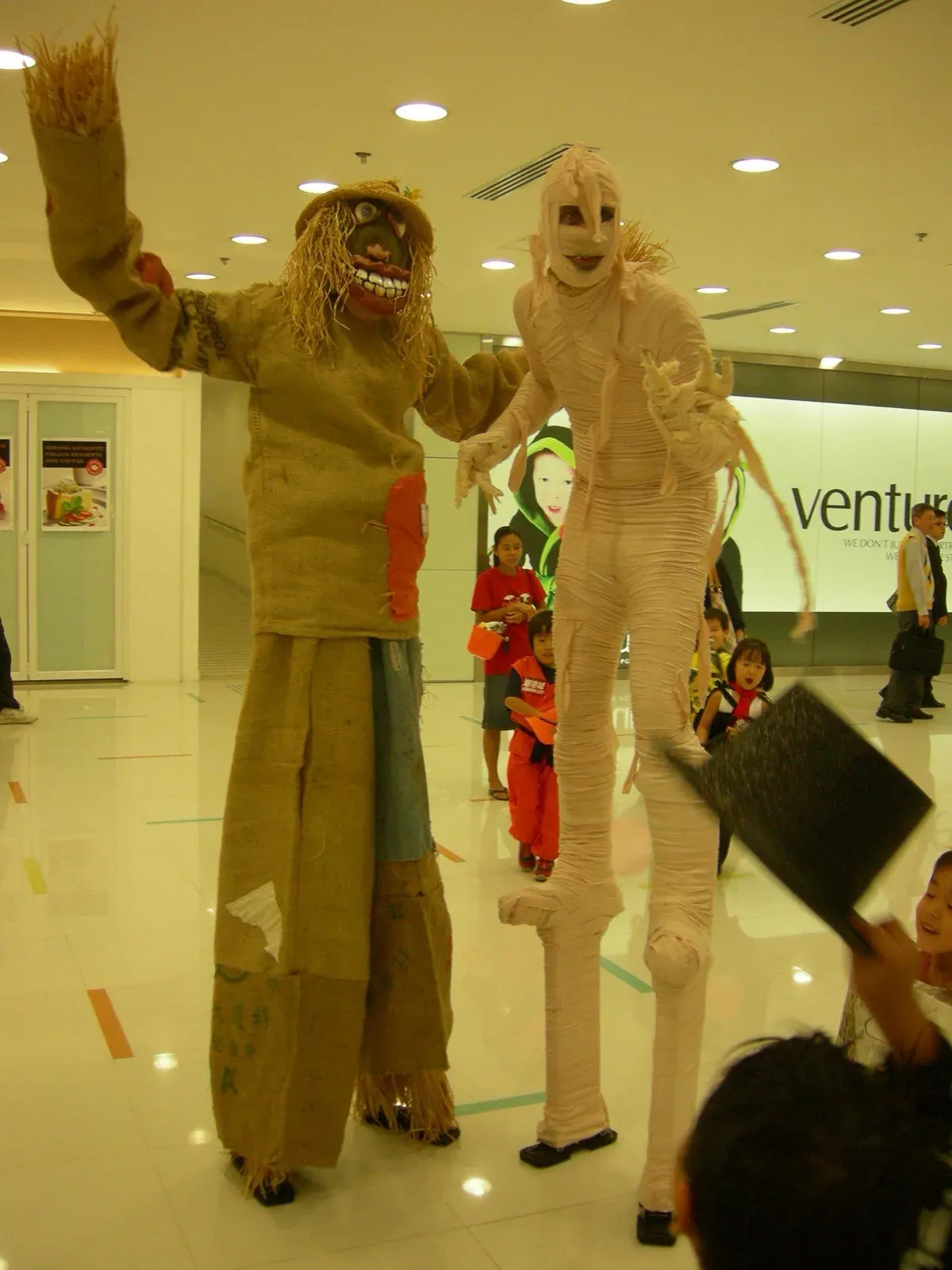 Hong Kong mall Halloween event with scarecrow & mummy stilts walker