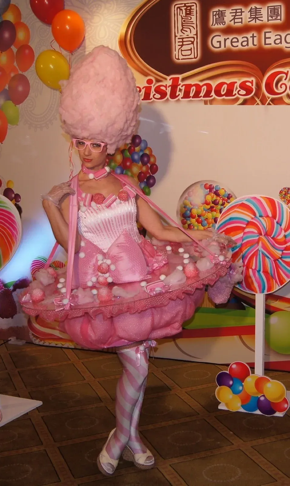 Pink candy girl character with a candyfloss wig at a sweets-themed event
