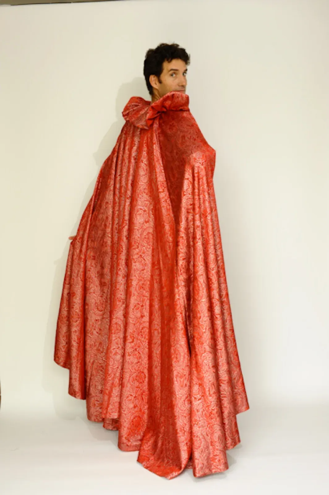 Performer wrapped in a large red cape