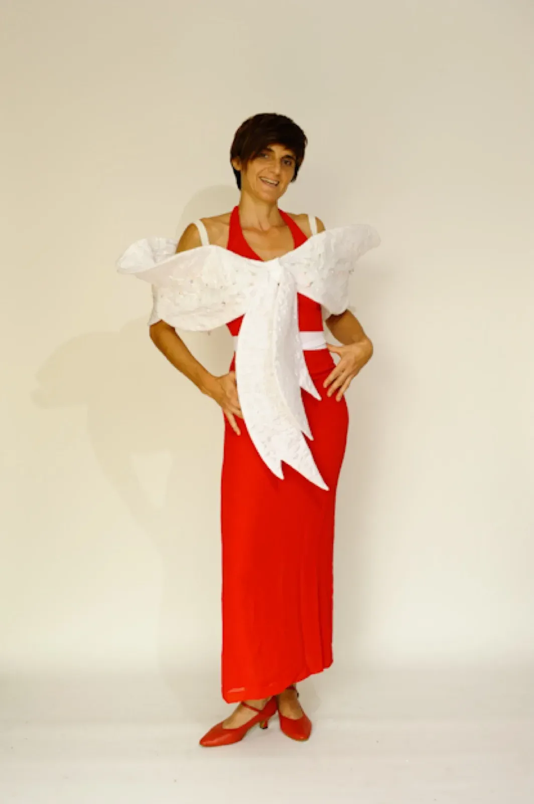 Performer in a long red dress with a large white bow