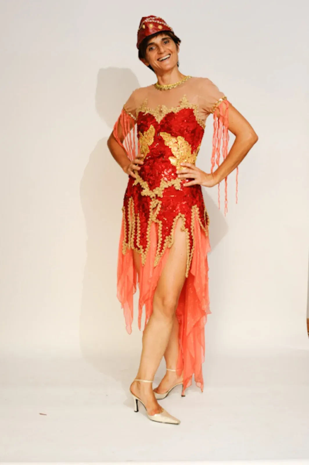 Dancer in a red warrior-style costume with flowing veils