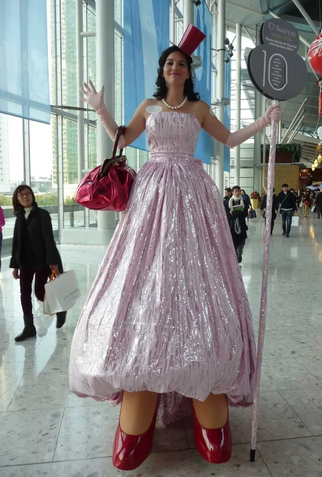 hong kong shopping mall promotion with pink dress lady stilts walker