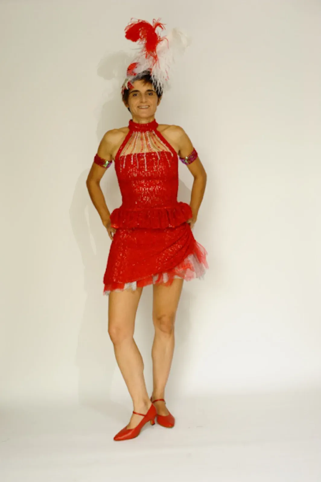 Performer in a short red dress with a red feather headpiece