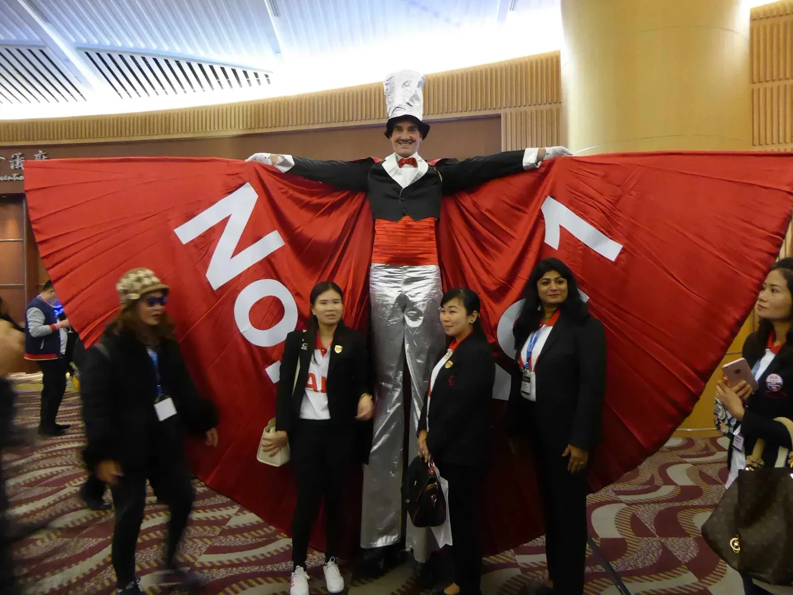 hong kong stilts walker with red cape for promotion campaign