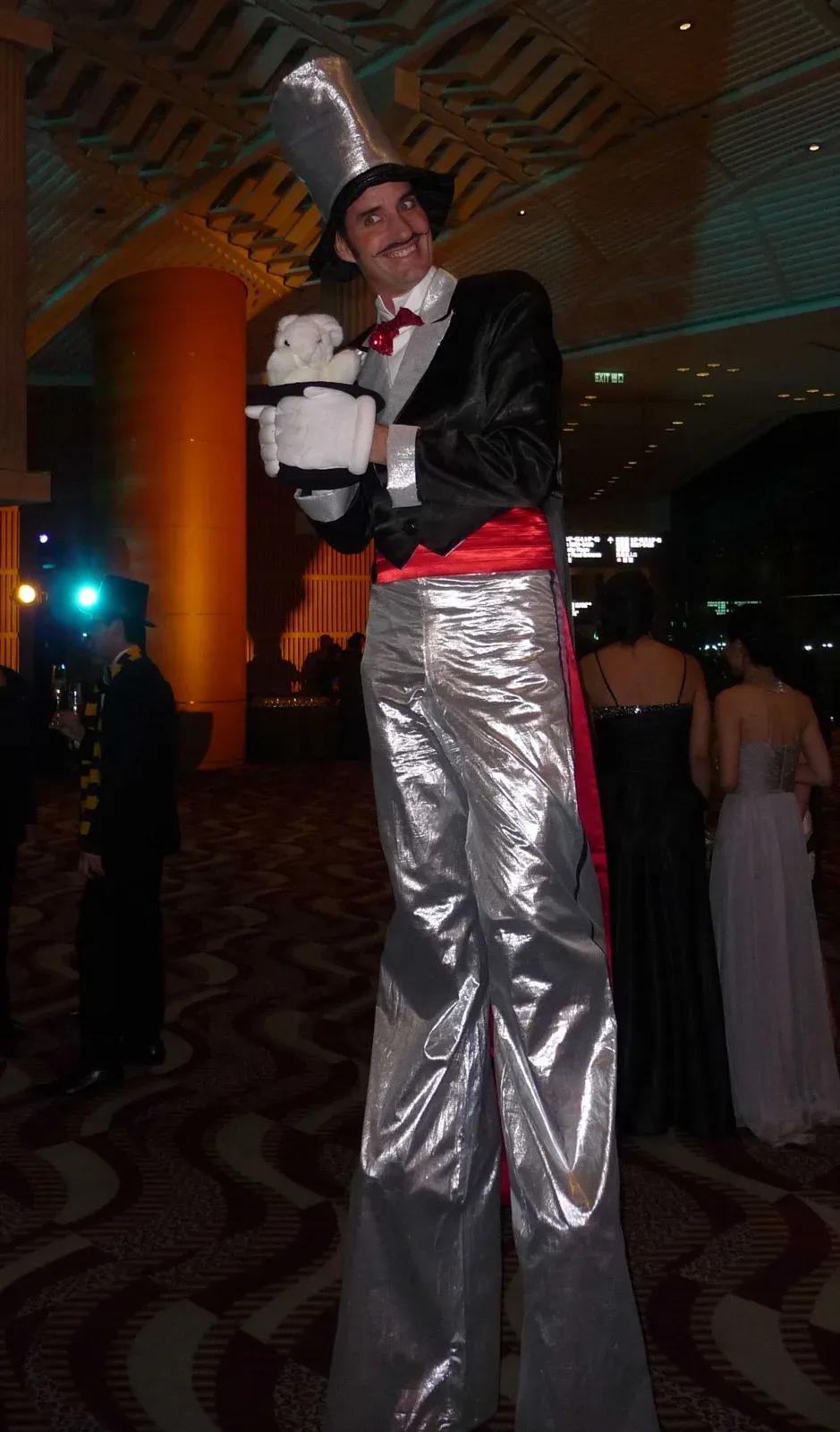 hong kong tall stilts walker perform magic to greet guests at cocktail event