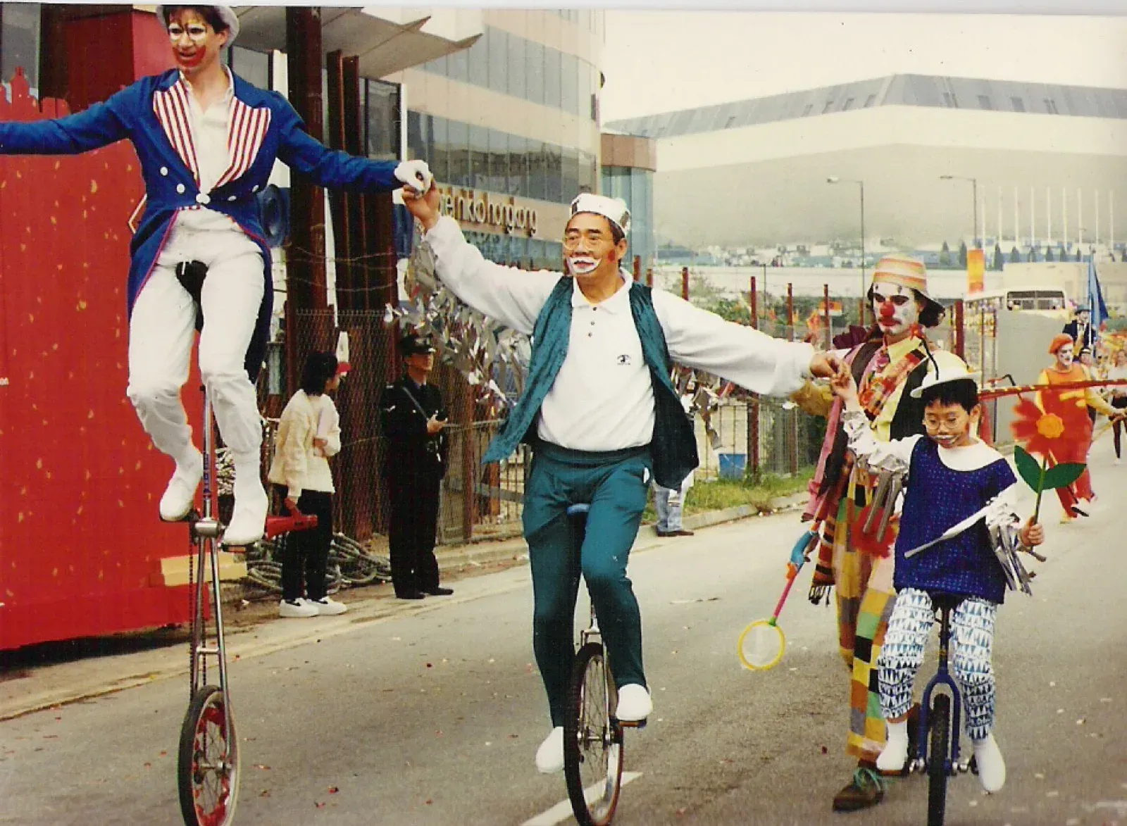 Unicycle riders and performers in a street parade in Hong Kong