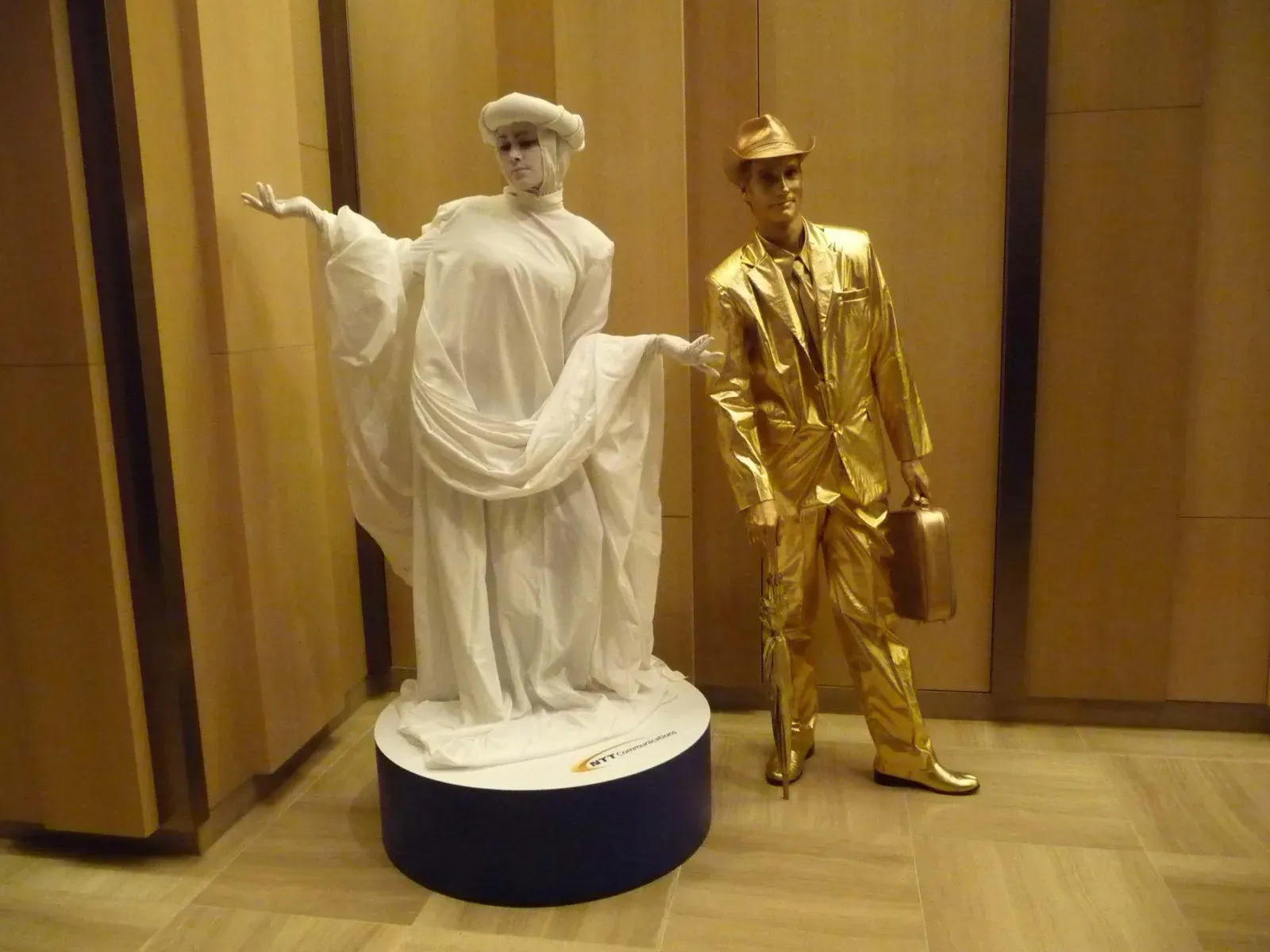 living statue mime in hong Kong with white dress & gold suit costume