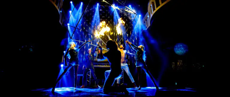 Fire performers and dancers inside a cube on stage in Macau