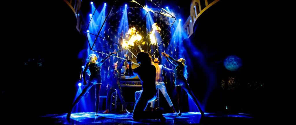 Fire performers and dancers inside a cube on stage in Macau