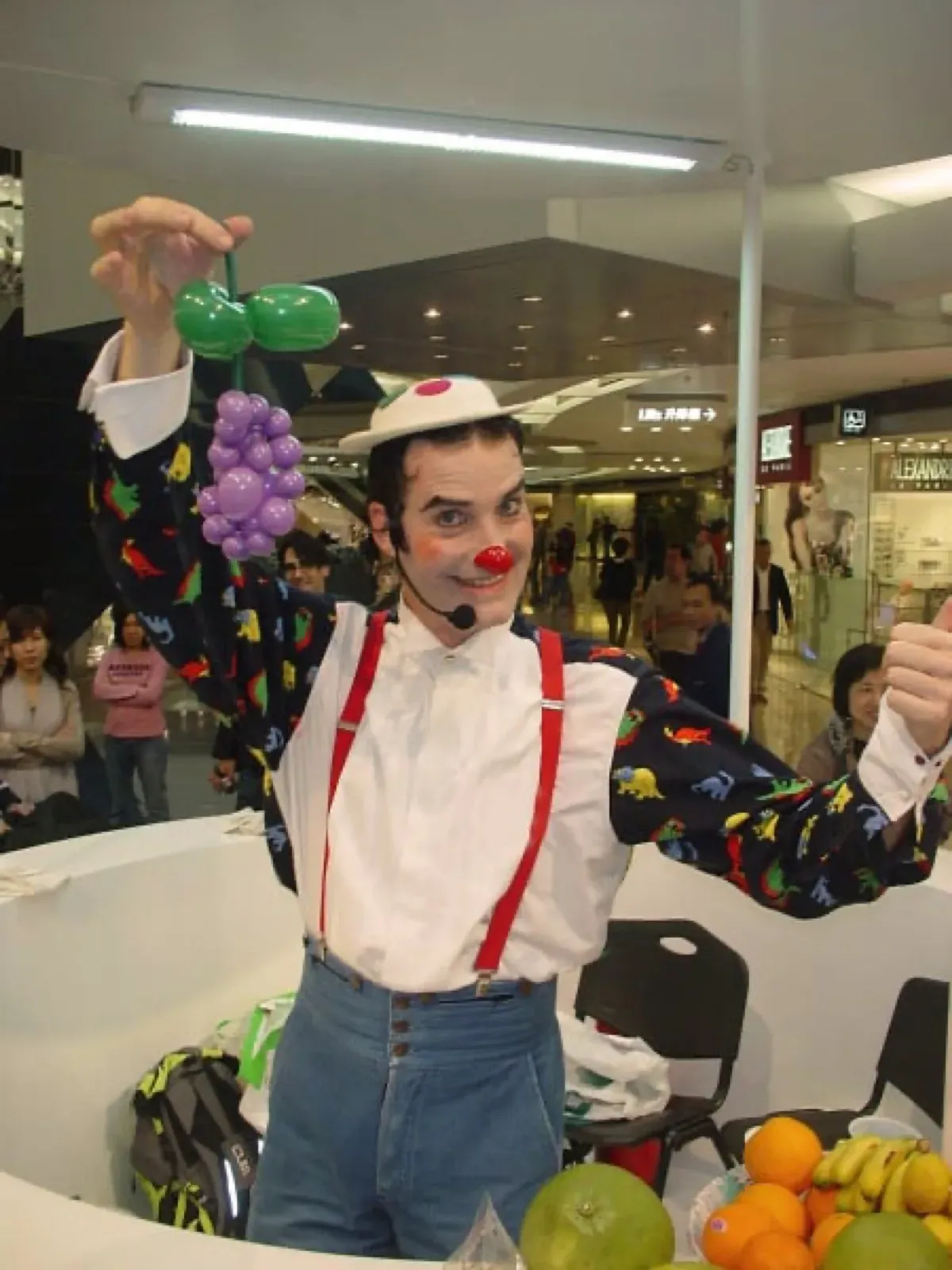 Performer in Hong Kong juggle with fruits for healthy food promotion in a shopping mall