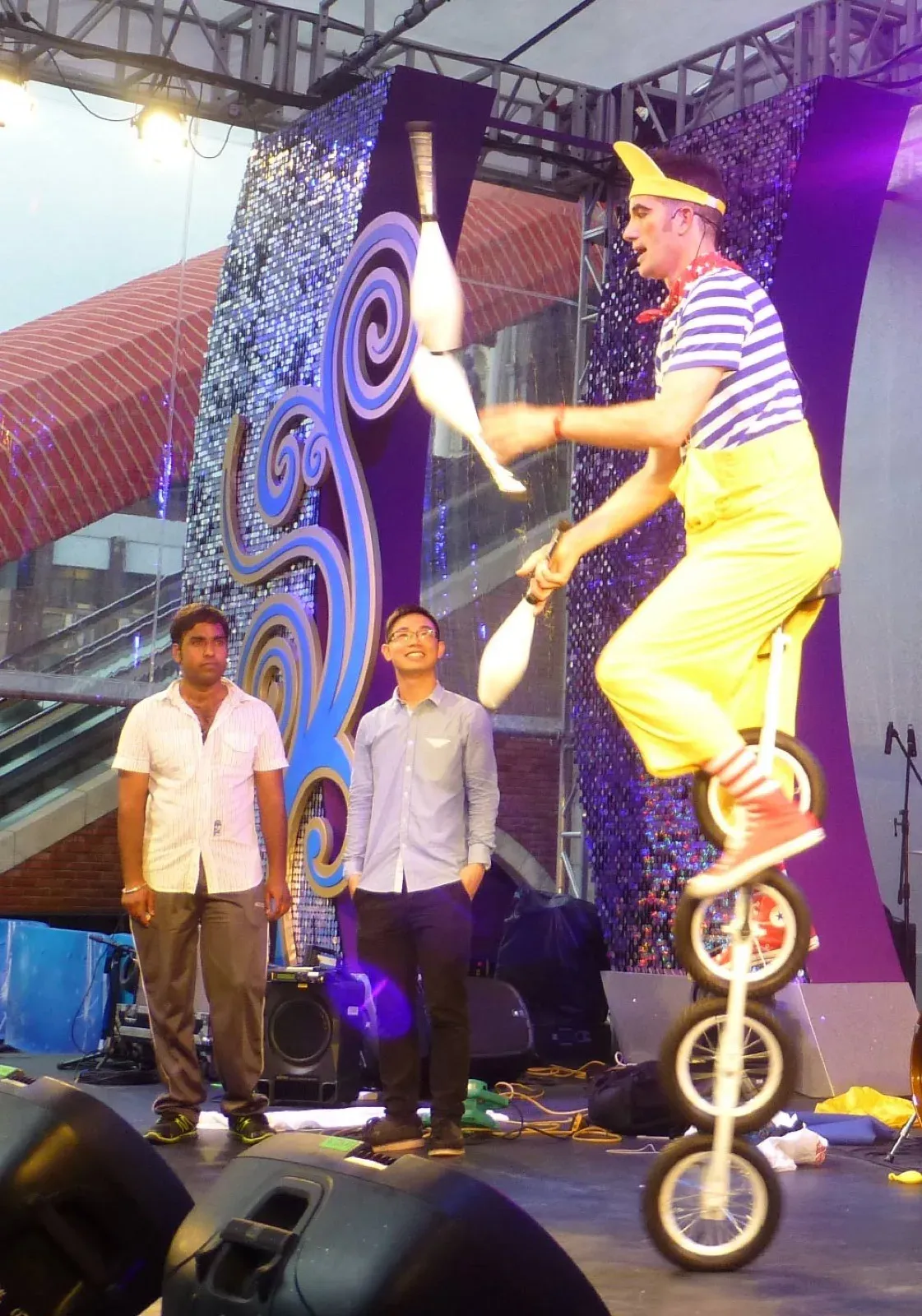 Performer juggle clubs on unicycle in Macau