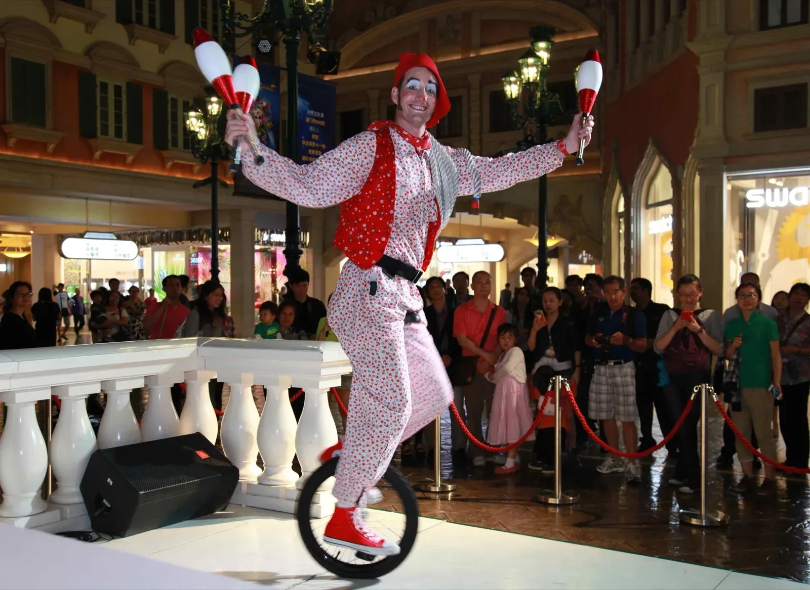 performer with juggling club ride a unicycle in Macau