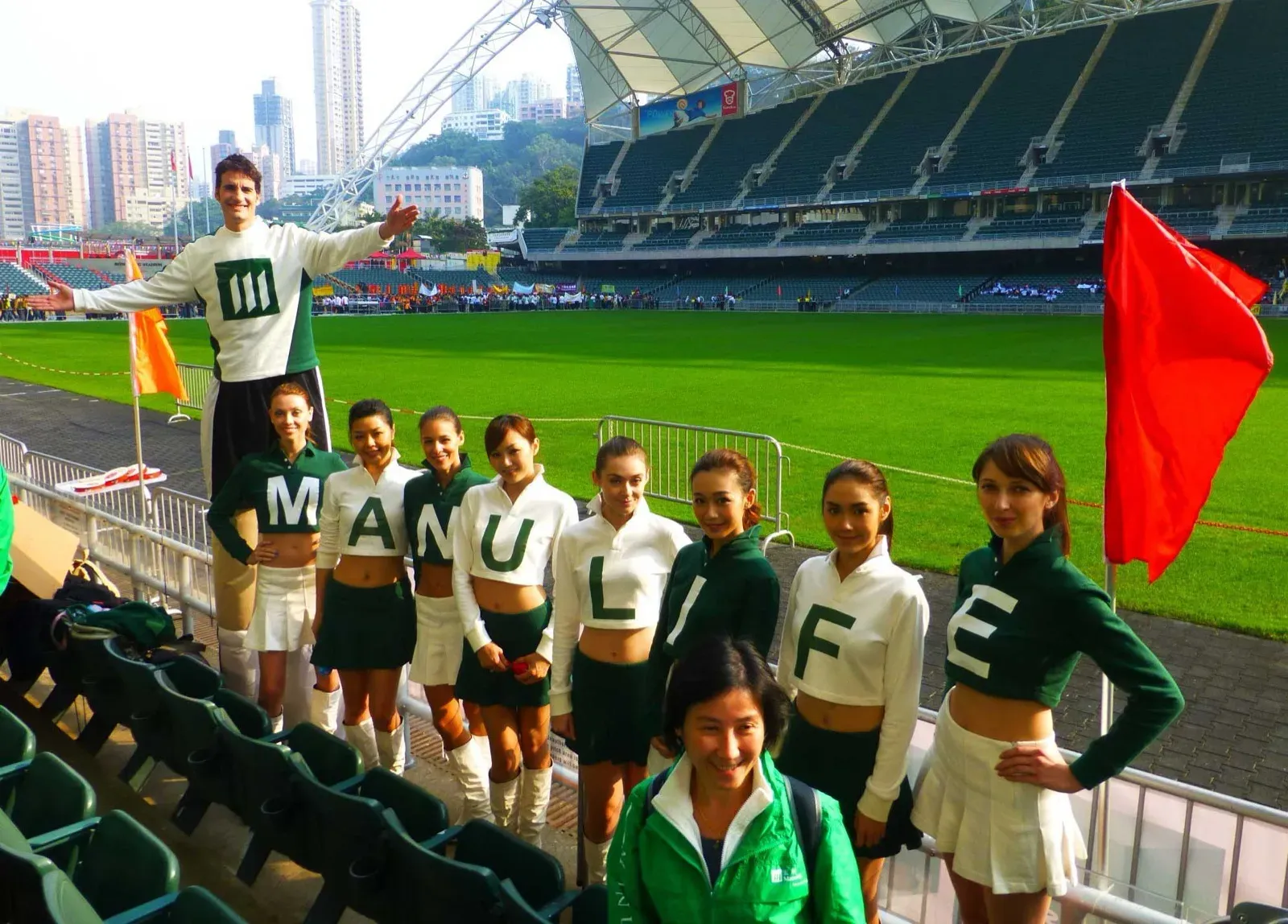 Cheerleaders spelling MANULIFE with a stilts walker at Hong Kong Stadium