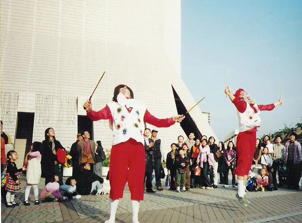 Performers in a circle at a street show