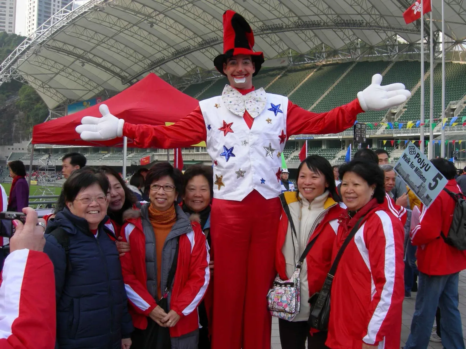 Tall clown on stilts in hong kong charity event