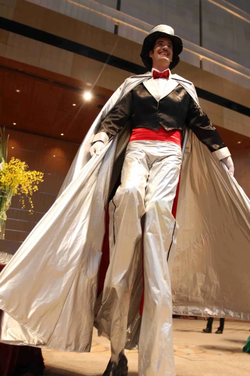 Tall stilts walker with silver cape for roving corporate function in Hong Kong