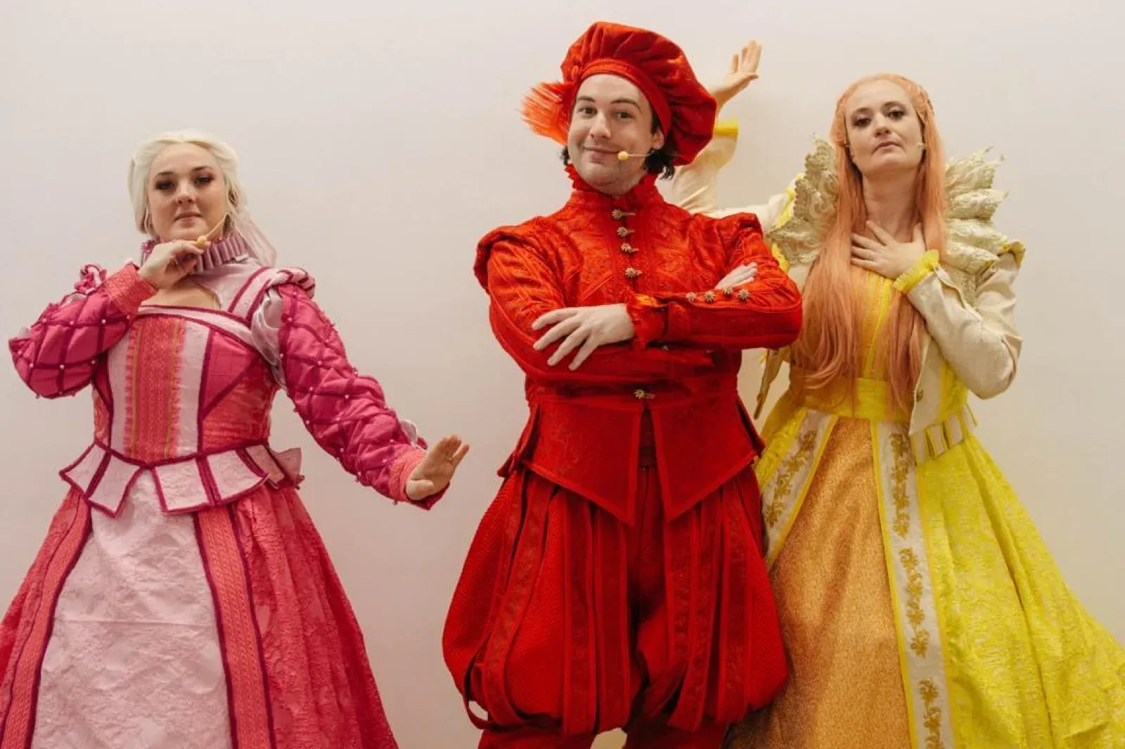 Three theatre actors in colourful Renaissance costumes with headset microphones in Hong Kong