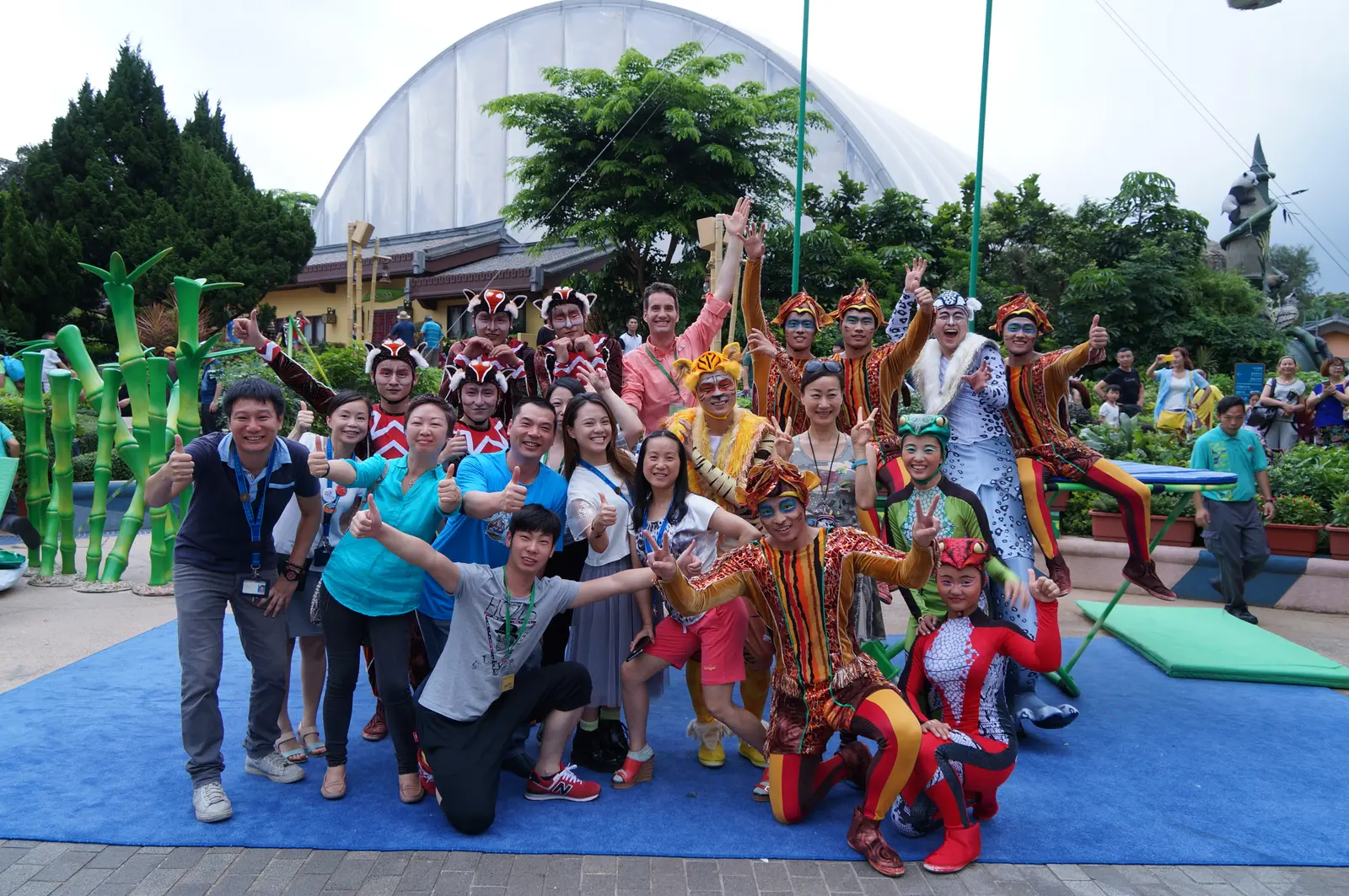 Performers in striped costumes at the Bamboo Jam opening on an outdoor stage